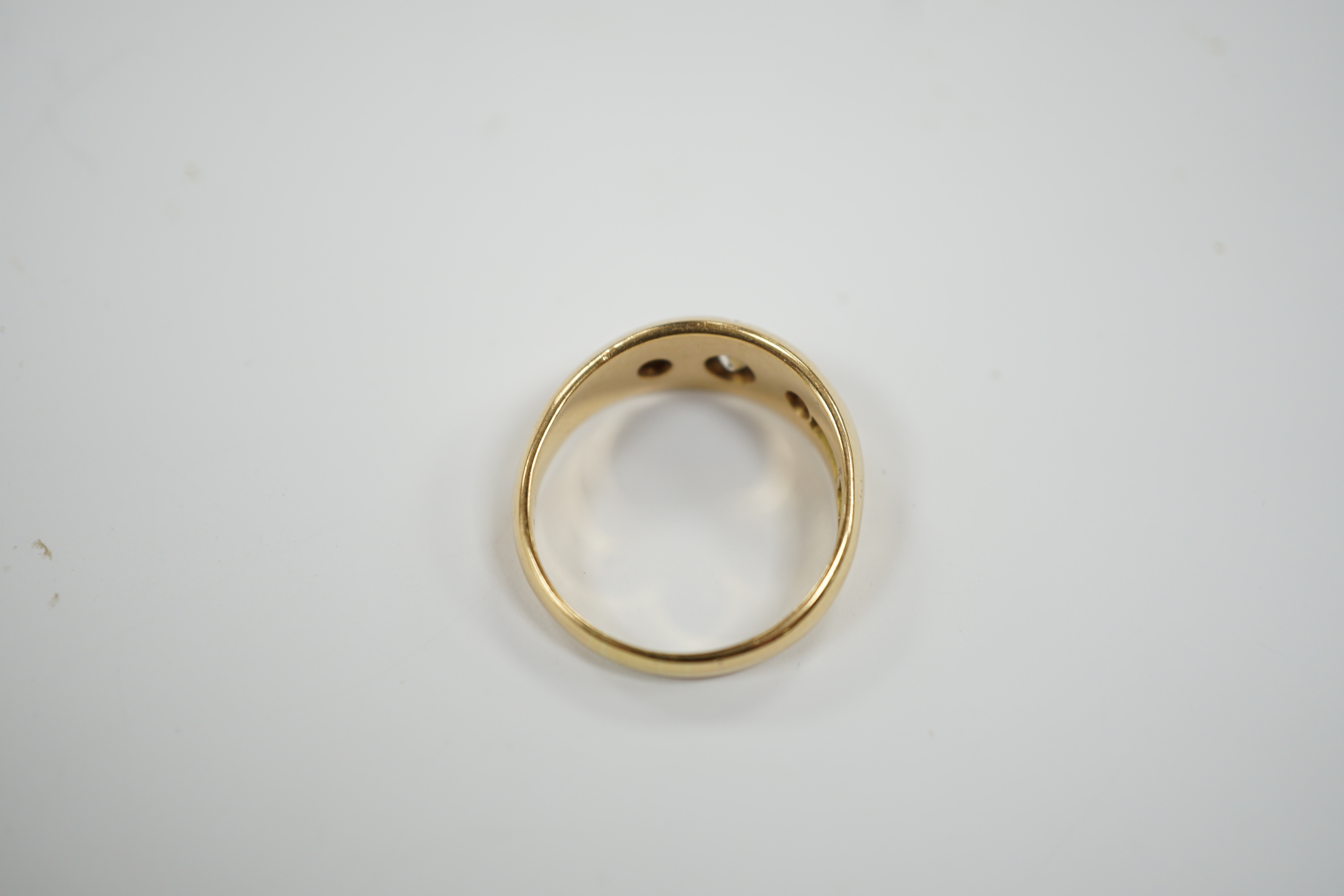 An Edwardian 18ct gold and gypsy set three stone diamond ring, size Q, gross weight 6.3 grams.